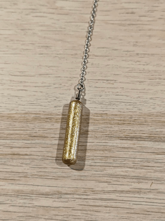 Pendule baton - doré