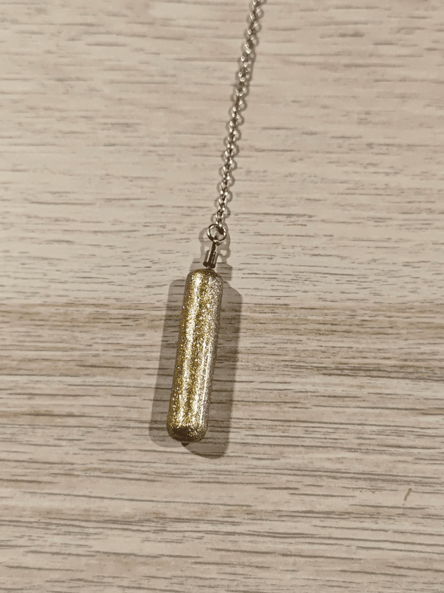 Pendule baton - doré